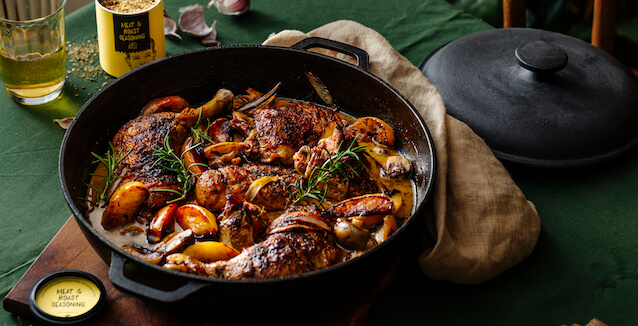Chicken Normandy in cast-iron pan with lid and wooden board, with Meat & Roast Seasoning from Just Spices