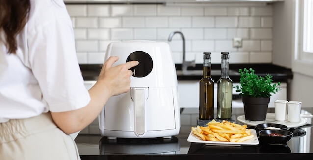 Woman cooking with an air fryer