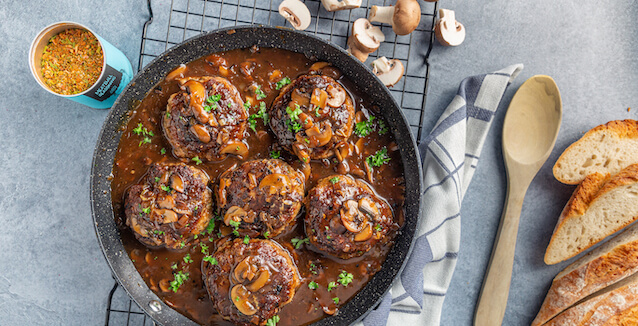 Meatballs in mushroom sauce in large pan from Just Spices