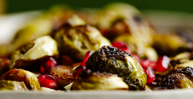 Roasted Brussels sprouts with pomegranate seeds, close up